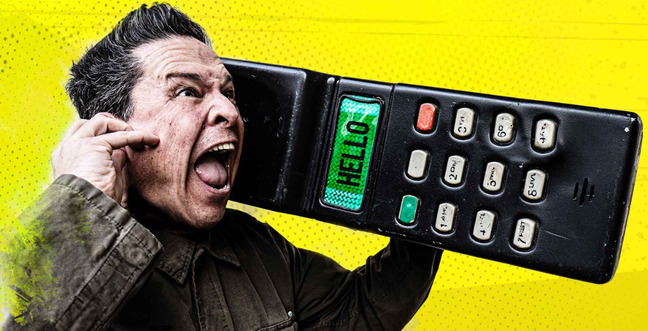 A man against a bright yellow backdrop holds a large phone with the word 'Hello' on the green phone screen