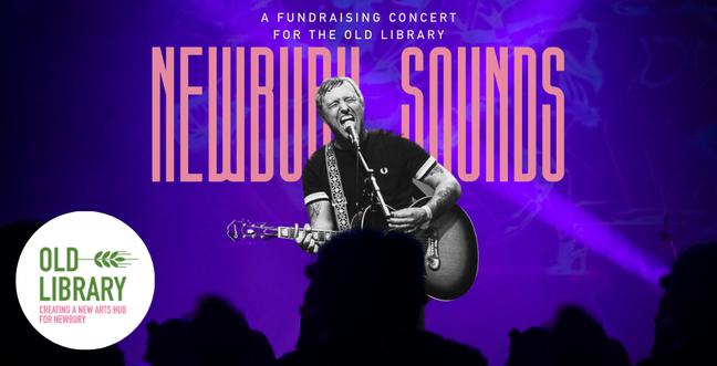 A man in black and white stands in front of a pink title saying 'Newbury Sounds' on a purple-lit stage