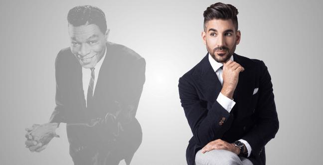 A modern, well-dressed man sits thoughtfully beside a faded grayscale image of Nat King Cole, creating a contrast between past and present.