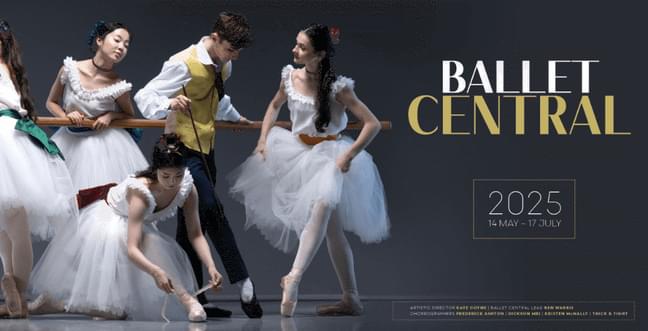 A group of ballerinas lean on a wooden balance bar wearing white dresses and one wearing a yellow waist coat and white shirt. To the right of them is a dark grey back drop with the title 'Ballet Central'