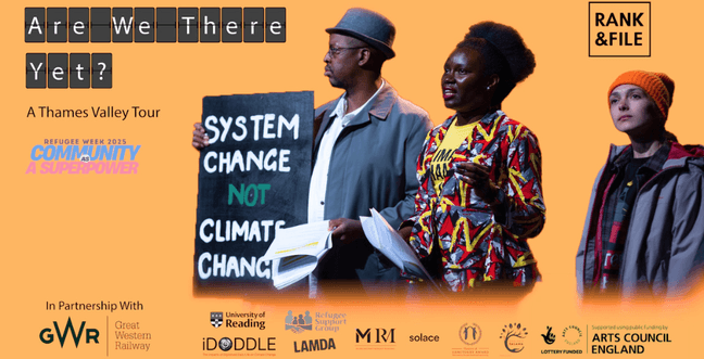 A group of people stand in a line holding up a banner that says 'System Change, not Climate Change'