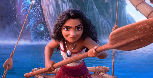 A cartoon girl with long dark curly hair holds a boat paddle while sailing on the sea