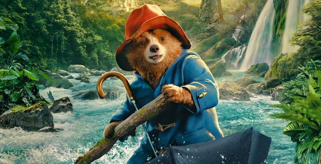 bear in a red had and blue duffle coat on a raging river using an umbrella as a boat in a rainforest setting