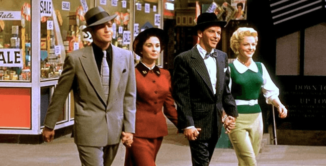A group of people walk down the street