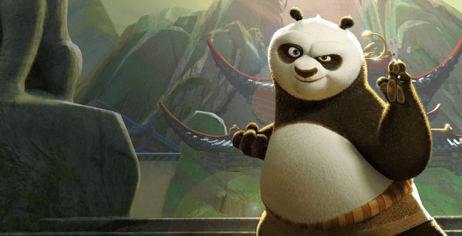 A panda stands with his arms up ready to fight