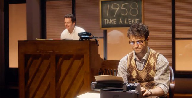 Daniel Radcliffe's character sits in the foreground, reading something on a typewriter. Behind him, a man plays the piano, and a sign reads '1958 take a left'.