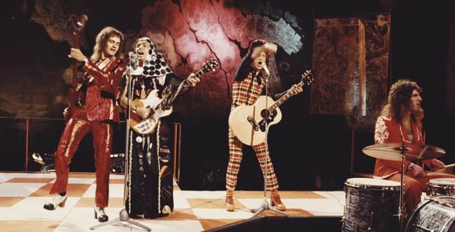 A band on stage wearing bright outfits