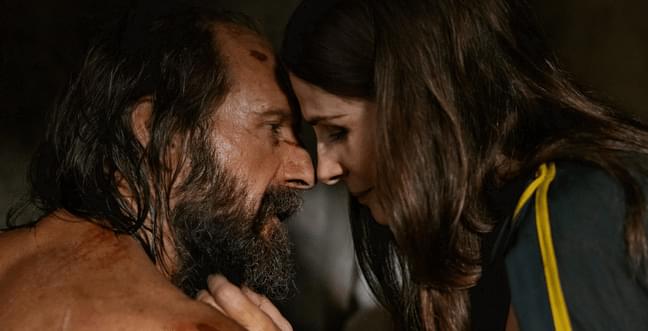 A middle-aged man and woman lovingly press their foreheads together