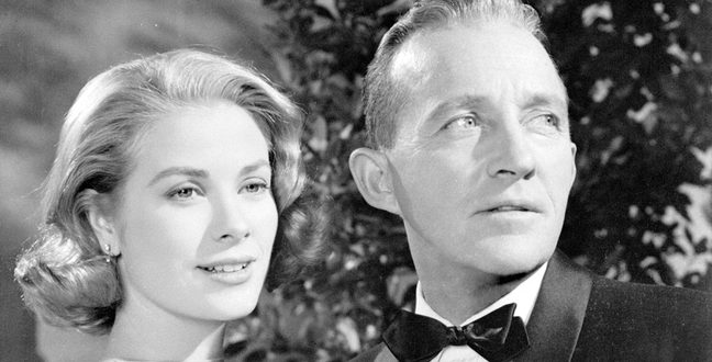 A black and white image of Grace Kelly and Bing Crosby stood next to each other