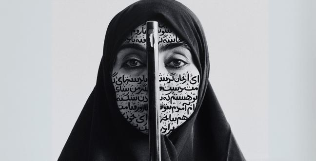 A woman in a hijab who has writing all over her face