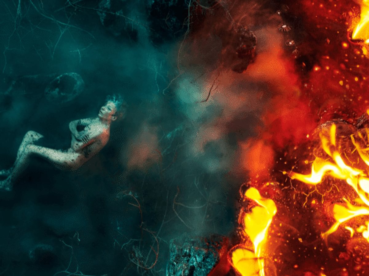 A woman submerged in blue ice on the left side and red fire on the right side.