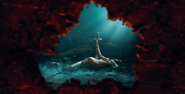 A person lies in a misty forest with a dagger pointing to their side