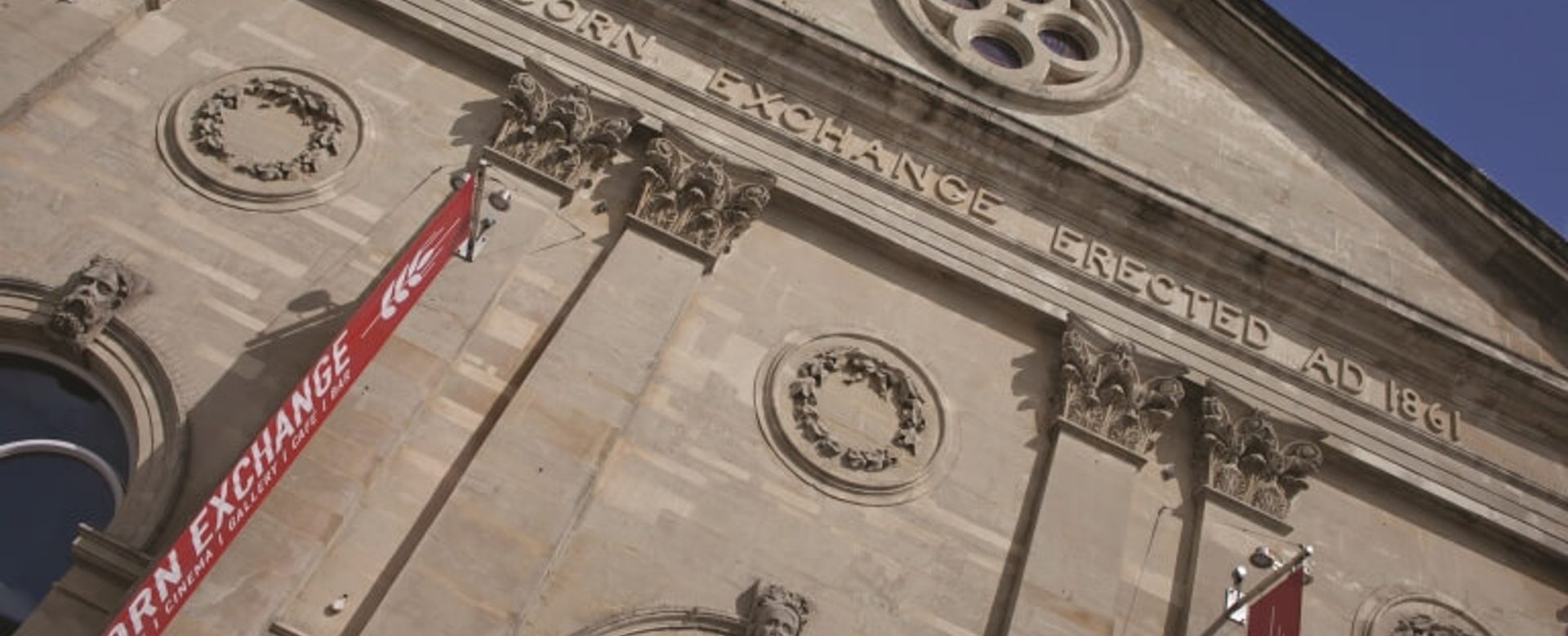A close up of the top of the Corn Exchange building with blue sky in the corner
