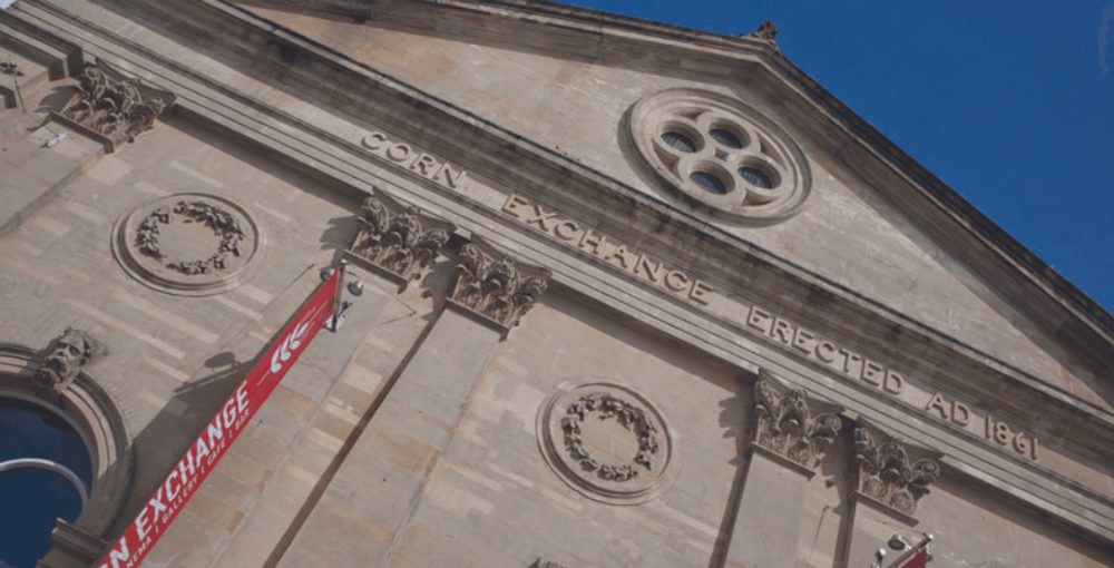A close up of the front of the Corn Exchange building with blue sky