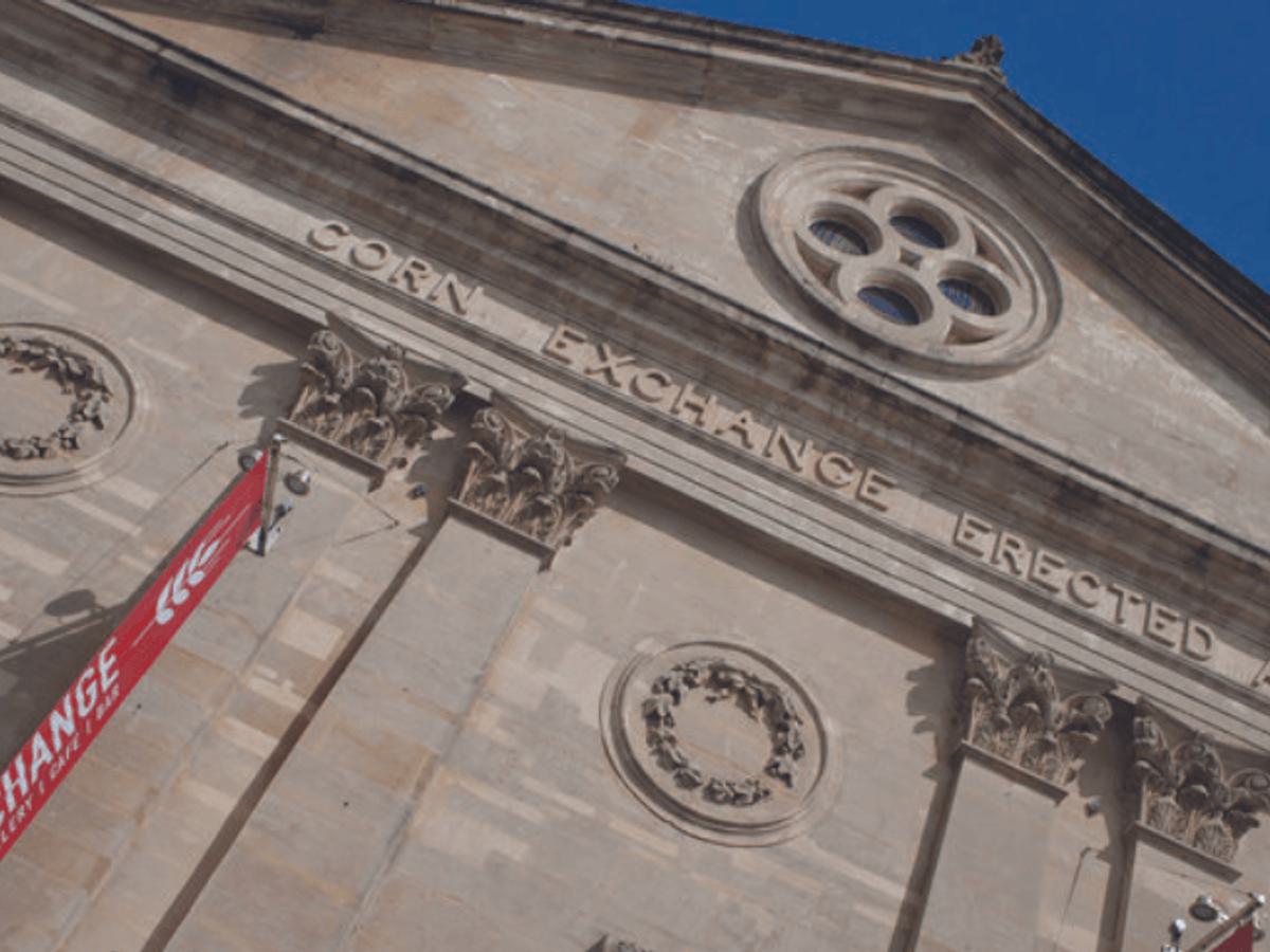 A close up of the front of the Corn Exchange building with blue sky