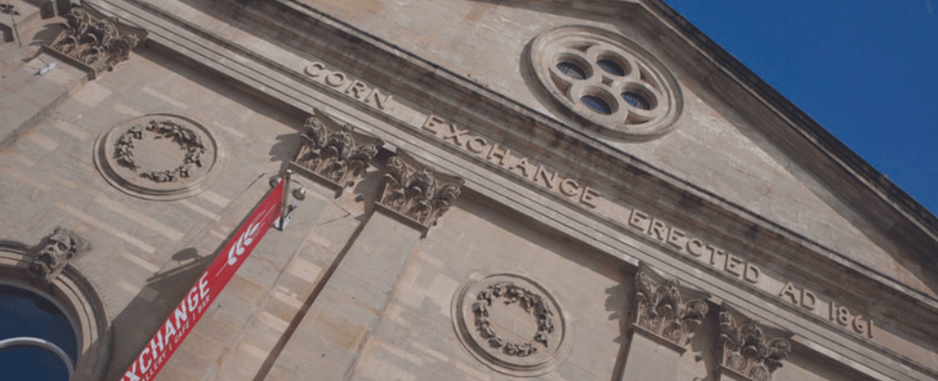 A close up of the front of the Corn Exchange building with blue sky
