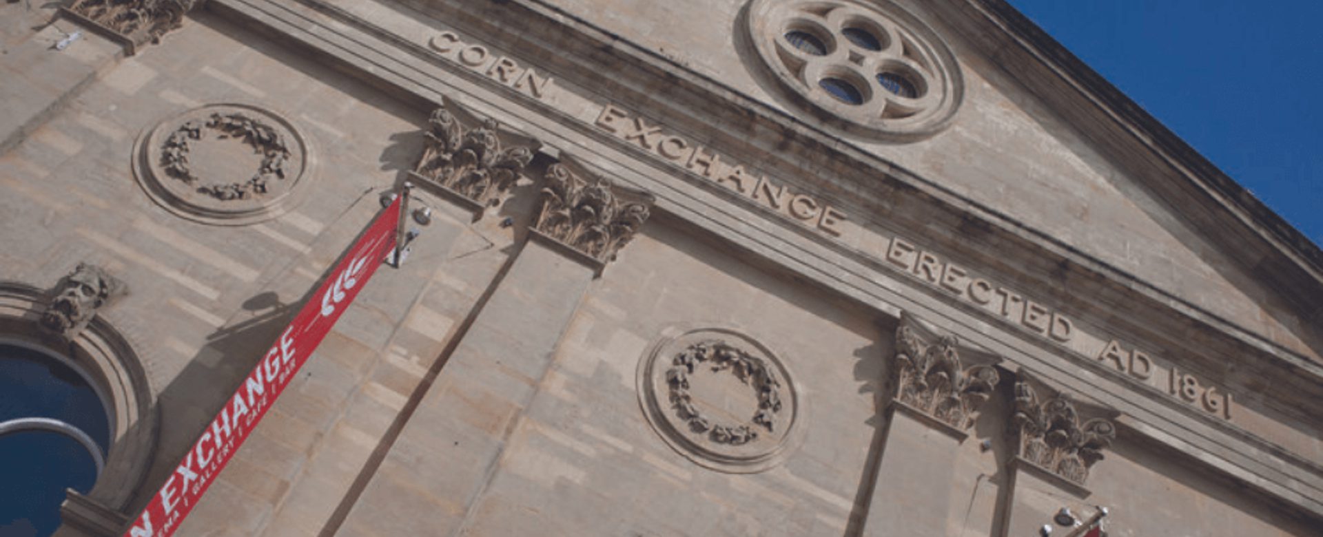 A close up of the front of the Corn Exchange building with blue sky