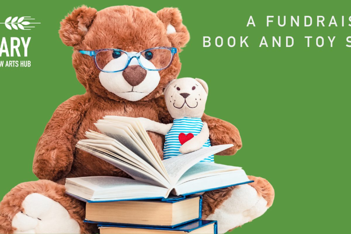 A teddy bear with glasses and books against a green backdrop