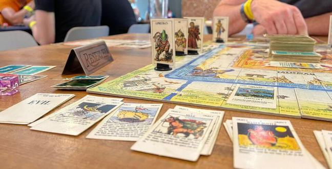 Playing cards and a board game on a wooden table