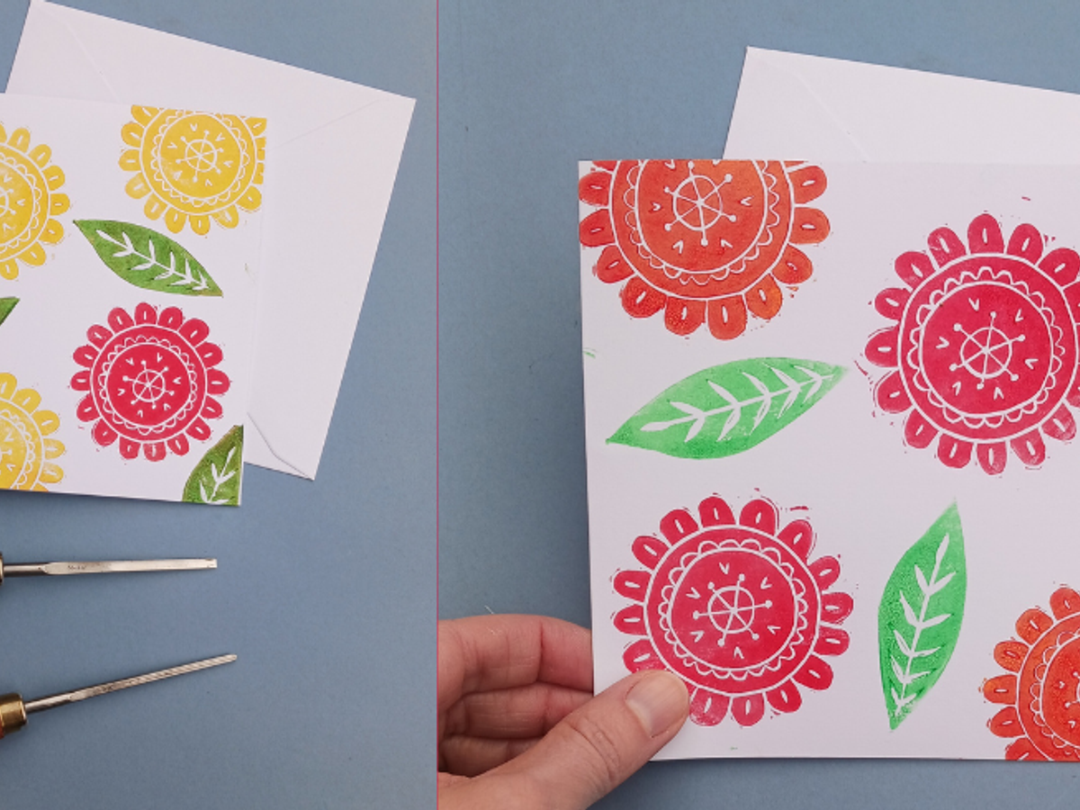 A floral print on a grey backdrop with two lino cutters with wooden handles beside the print