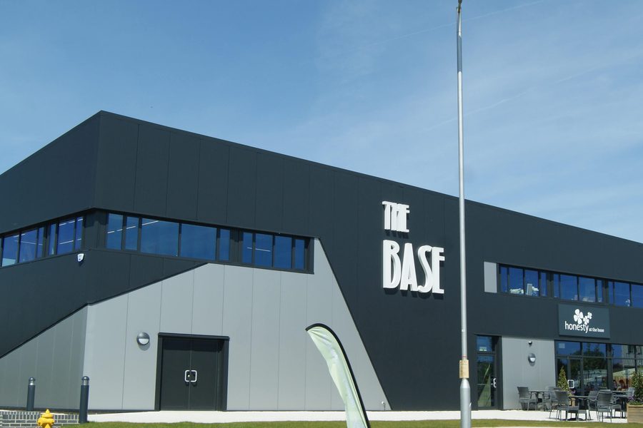 The base grey and black building against a blue sky