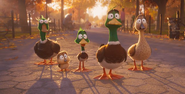 Four cartoon ducks stand in a line with the sun setting behind them